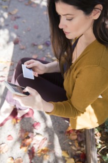 Caucasian woman online shopping with cell phone in autumn