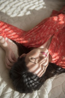 Shadows on Caucasian woman sleeping on bed