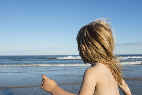 Wind blowing hair of Caucasian girl on beach