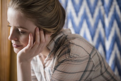 Pensive woman with hand on chin