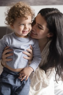 Caucasian mother hugging son