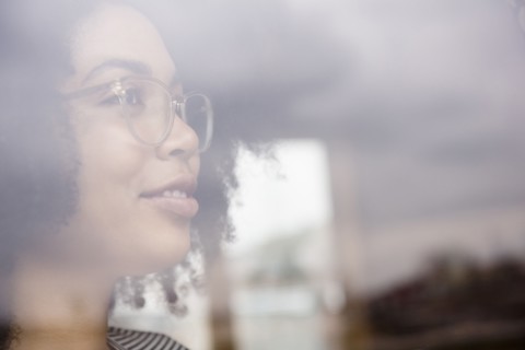 Smiling African American woman behind window