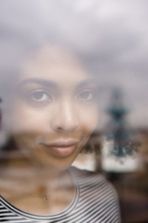 Smiling African American woman behind window