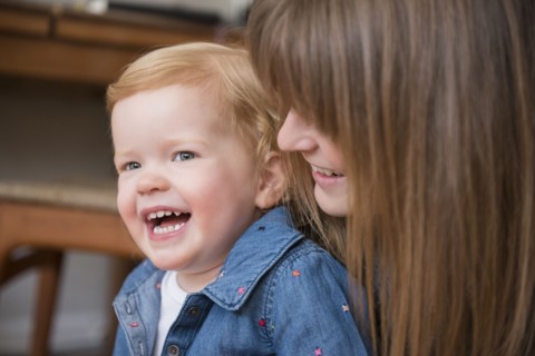 Laughing Caucasian mother and daughter