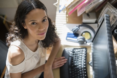 Portrait of Hispanic woman using computer