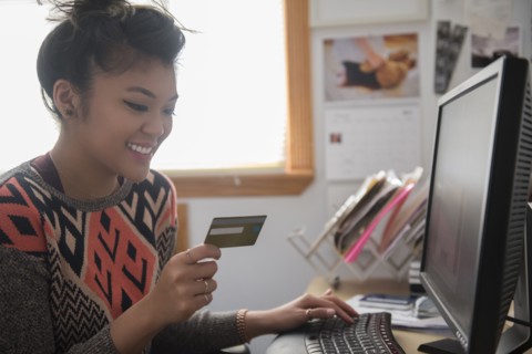 Mixed Race woman online shopping using computer