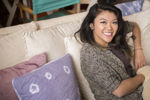 Portrait of smiling Mixed Race woman sitting on sofa