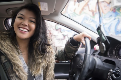 Portrait of smiling Mixed Race woman driving car
