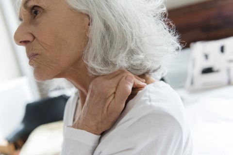 Older woman rubbing the neck