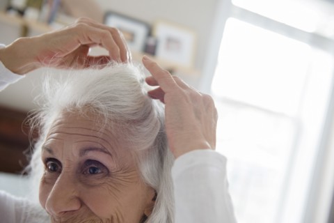 Older woman arranging hair