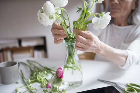 Older woman arranging flowers