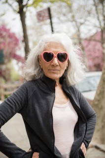 Older woman wearing heart-shape sunglasses