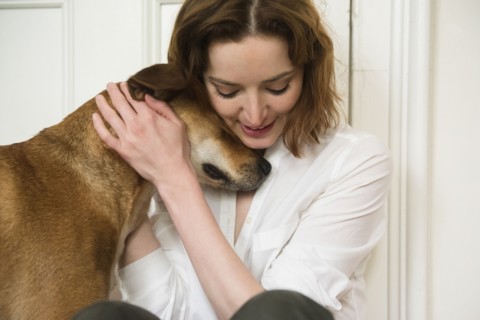 Caucasian woman hugging dog