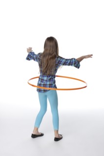 Caucasian girl twirling plastic hoop