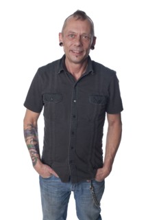 Tattooed Caucasian man with hands in pockets