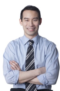 Smiling Chinese businessman with arms crossed