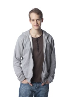 Smiling Caucasian man with hands in pockets