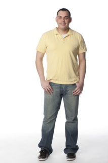 Smiling Hispanic man with hands in pockets
