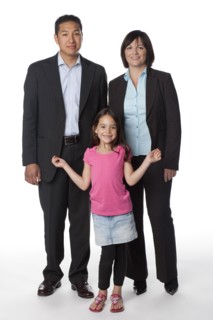 "Smiling mother, father and daughter"