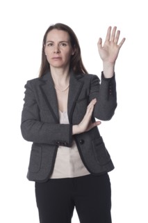 Serious Caucasian businesswoman with arms raised