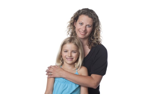 Caucasian mother hugging daughter
