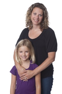 Caucasian mother hugging daughter