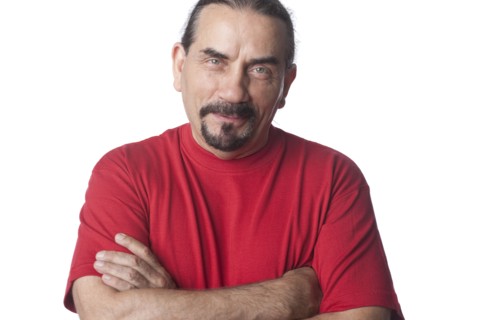 Mixed race man with arms crossed