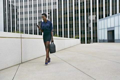 African American businesswoman walking on city street