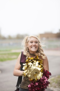 Caucasian cheerleader cheering in parking lot