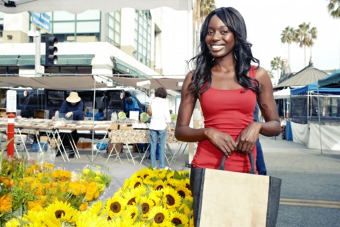 African American woman buying flowers