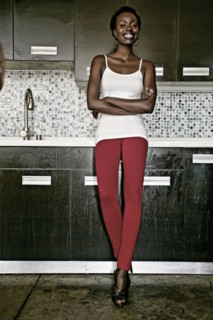 Black woman smiling in kitchen