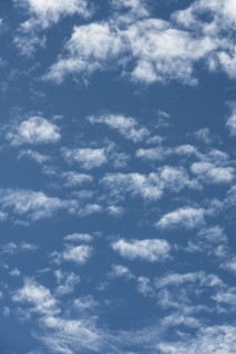 Puffy white clouds in blue sky
