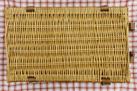 Overhead view of closed wicker picnic basket