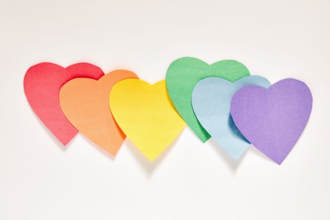 Studio shot of row of rainbow color Paper hearts