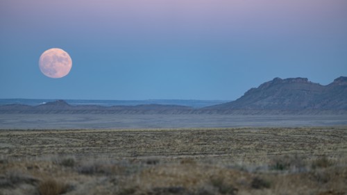 Full moon rising over Navajo Nation desert landscape