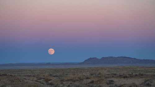 Full moon rising over Navajo Nation desert landscape