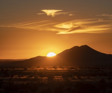 Sun setting above hill in Cerrillos Hills State Park