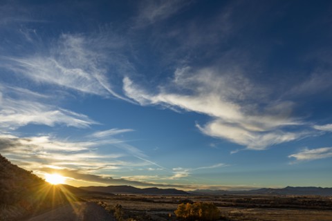 Sun setting behind hills