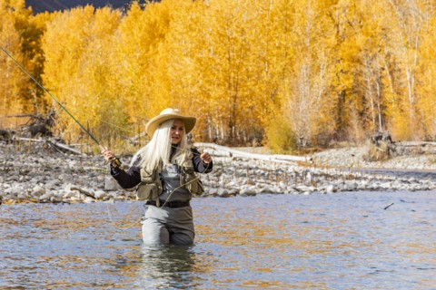 Senior woman fly-fishing