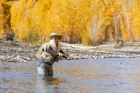 Senior woman fly-fishing