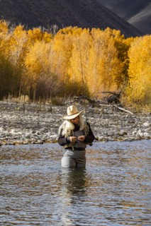 Senior woman fly-fishing