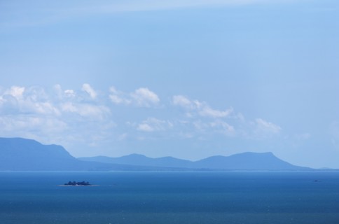 Blue sky over sea and mountains