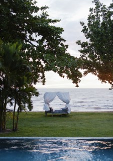 Canopy bed in hotel overlooking ocean