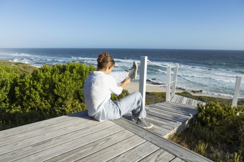 Girl sitting on boardwalk