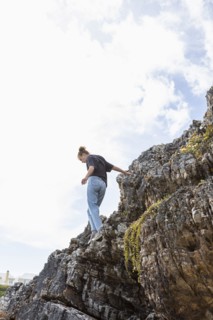 Girl balancing on rock at Grotto Beach