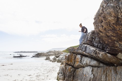 Girl balancing on rock at Grotto Beach