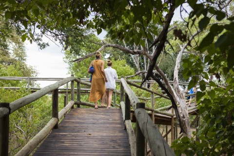 Mother and daughter on wooden walkway