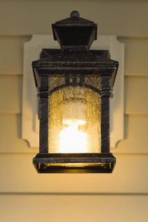 Electric lamp hanging on porch