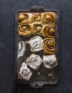Overhead view of freshly baked cinnamon buns on baking sheet
