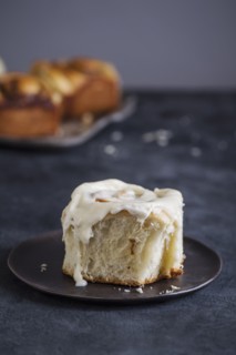 Cinnamon bun with icing on plate